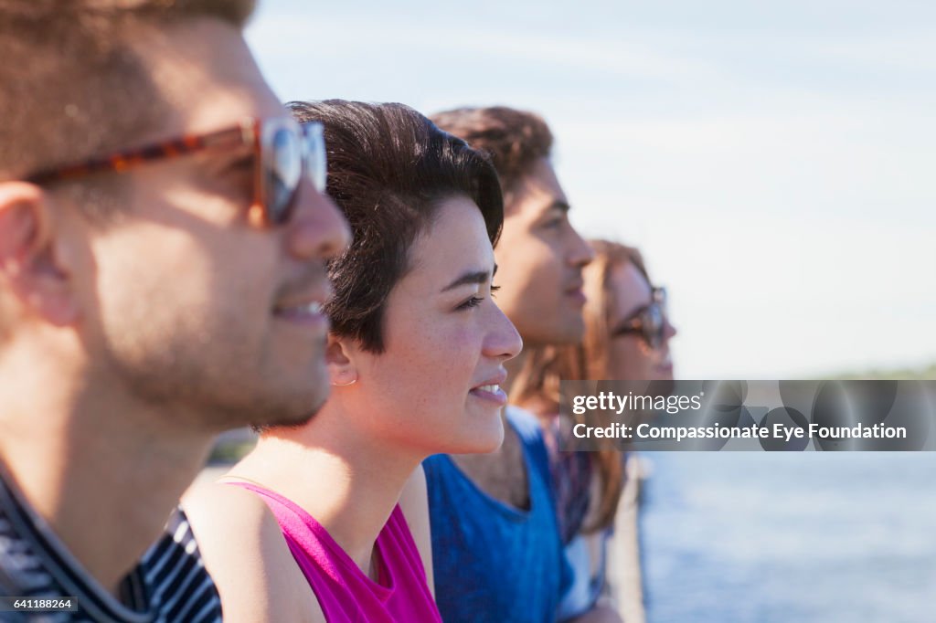 Friends Looking Portrait Of Smiling Friends Looking Out Across River High-Res Stock ...