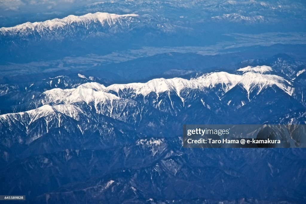 Snow capped Southern and Chuo Alps in winter aerial view from airplane