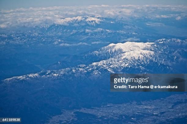 snow-capped northern and chuo alps in winter aerial view from airplane - 木曽山脈 ストックフォトと画像