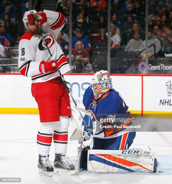 Goalie Jean-Francois Berube of the New York Islanders stops a shot by Elias Lindholm of the Carolina Hurricanes during an NHL hockey game at Barclays...