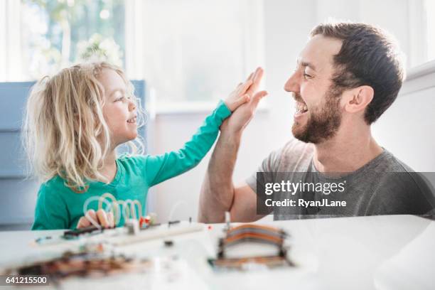 dad teaching daughter electrical engineering - adult encouragement and support stock pictures, royalty-free photos & images