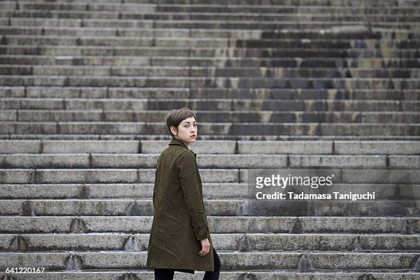 woman going up stairs - 階段　のぼる ストックフォトと画像