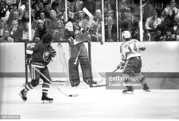 New York Islanders' goalie Billy Smith comes off the ice to block a goal attempt by St. Louis Blues Doug Palazzari in the first period of the game.