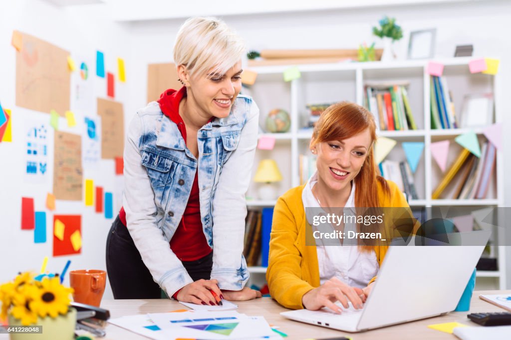 Attractive businesswomen working together in office on start up project