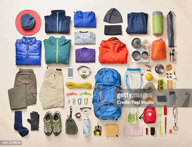 mountain climbing supplies shot knolling style - rucksack mit wanderschuhen stock-fotos und bilder