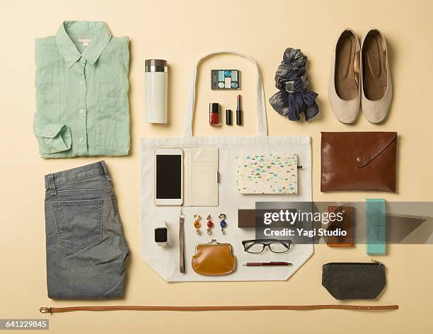 woman daily supplies shot knolling style. - top garment stock pictures, royalty-free photos & images