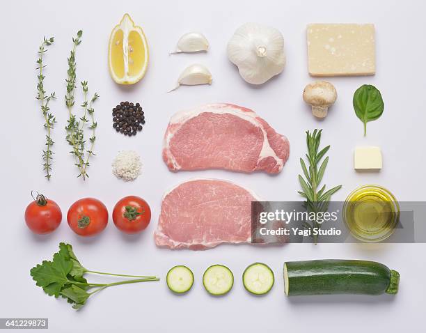 herb oil grilled pork loin knolling style - flatlay stock-fotos und bilder