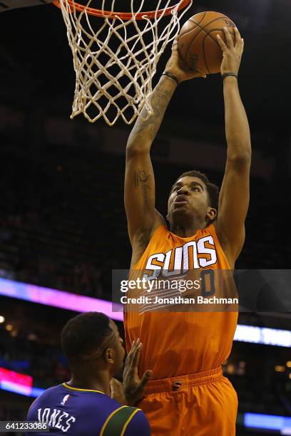 Marquese Chriss of the Phoenix Suns dunks over Terrence Jones of the New Orleans Pelicans during the first half of a game at the Smoothie King Center...