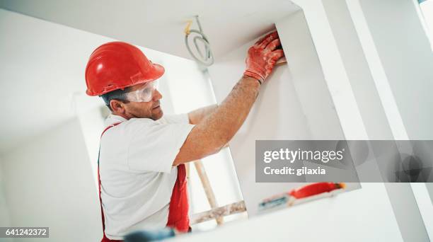 sanding a drywall. - interior design professional stock pictures, royalty-free photos & images