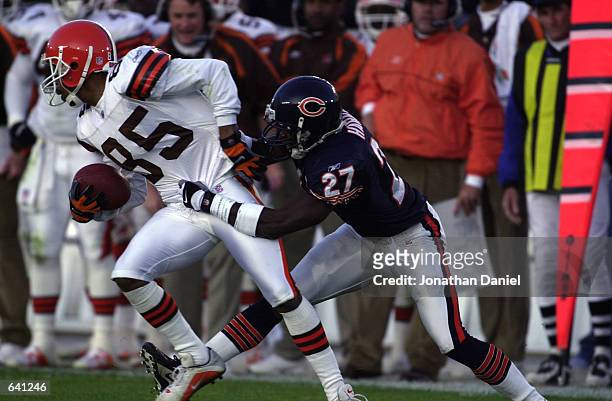 Receiver Kevin Johnson of the Cleveland Brown tries to break away from defender Walt Harris of the Chicago Bears in their game at Soldier Field in...