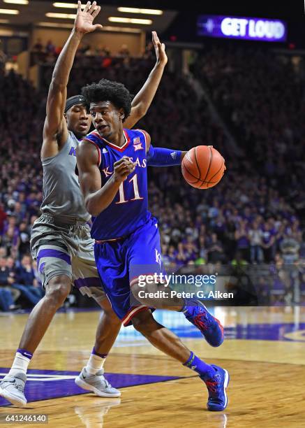 Guard Josh Jackson of the Kansas Jayhawks drives around guard Xavier Sneed of the Kansas State Wildcats during the first half on February 6, 2017 at...