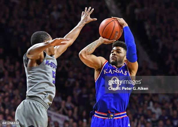 Guard Frank Mason III of the Kansas Jayhawks takes a shot against pressure from guard Barry Brown of the Kansas State Wildcats during the first half...