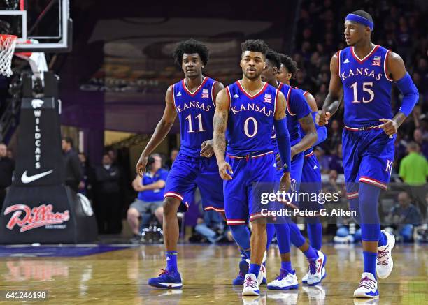 Guard Frank Mason III of the Kansas Jayhawks leads teammates Carlton Bragg Jr. #15 and Josh Jackson back onto the court against the Kansas State...