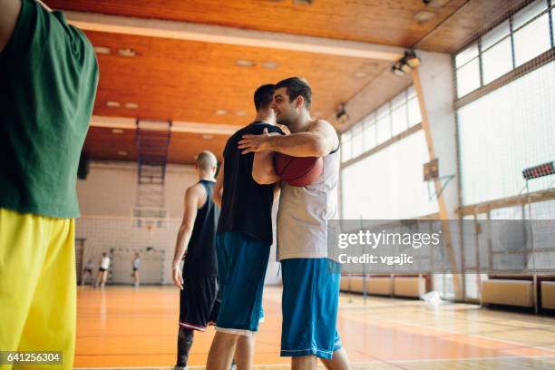 group of friends playing basketball - amateur sport stock pictures, royalty-free photos & images