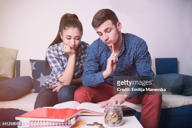 portrait of worried young couple reading financial documents - married imagens e fotografias de stock