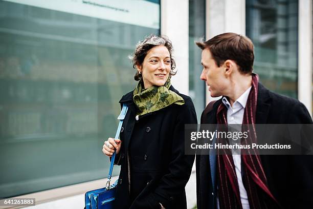 two mature business colleagues talking - buildings side by side stock pictures, royalty-free photos & images