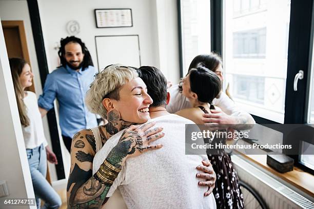 mature couple welcoming guests for dinner party - happy arrival stock pictures, royalty-free photos & images