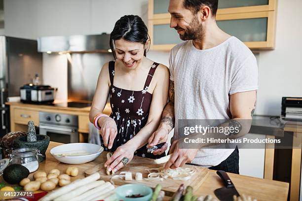 mature couple preparing food for dinner - couple candid stock pictures, royalty-free photos & images