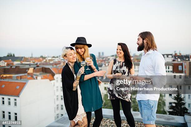 friends standing on rooftop and having fun - berlin party stock pictures, royalty-free photos & images