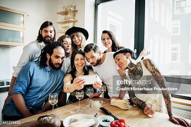 woman taking group selfie at party - looking at camera foto e immagini stock
