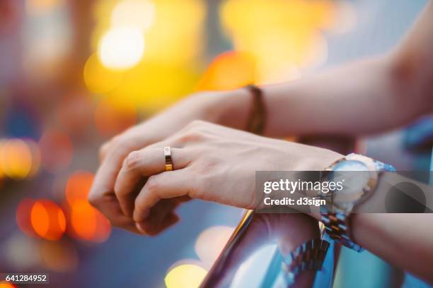 close up shot of woman's hand with a golden wedding ring - reloj de pulsera fotografías e imágenes de stock