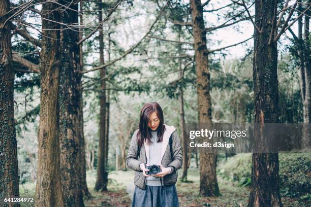 young girl taking pictures with camera in the countryside - eco tourism stock pictures, royalty-free photos & images