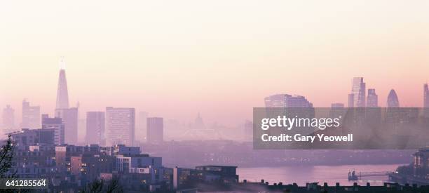 london city skyline and river thames in the fog - pale pink stock pictures, royalty-free photos & images