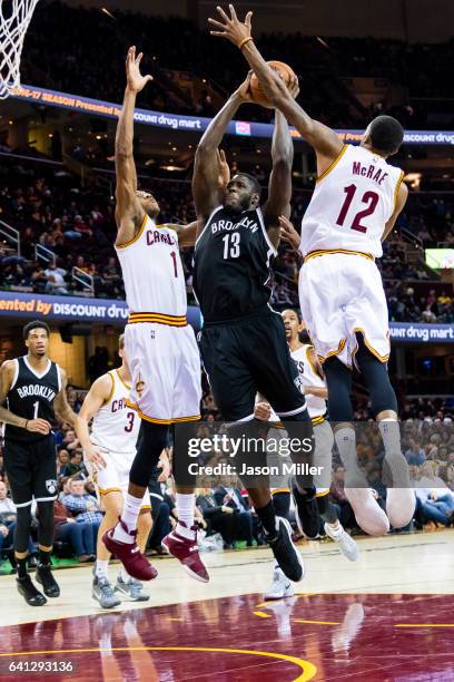 Anthony Bennett of the Brooklyn Nets shoots while under pressure from James Jones and Jordan McRae of the Cleveland Cavaliers during the second half...