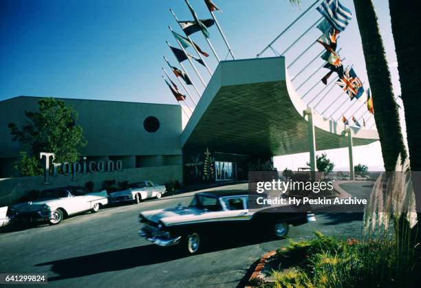 General view as an old car drives by on the outside of The Tropicana Hotel circa 1958 in Las Vegas, Nevada.