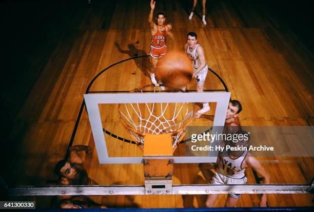 Med Park of the St. Louis Hawks shoots a free throw as Jack Parr and Jack Twyman of the Cincinnati Royals defend during their game on November 2,...