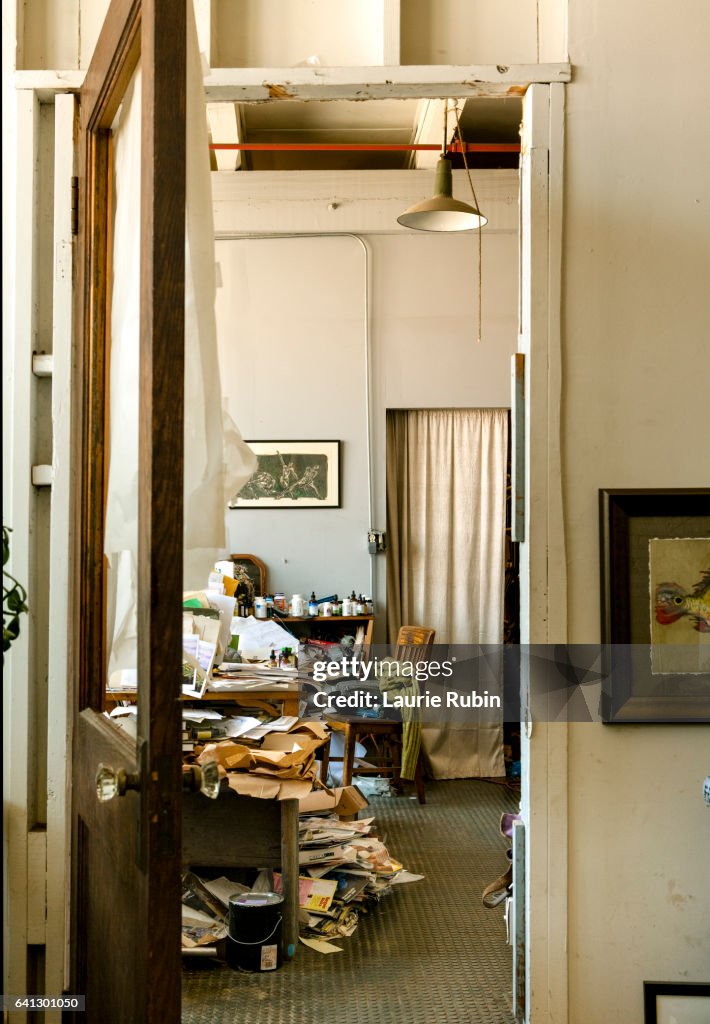 Messy, chaotic office with lots of papers and files