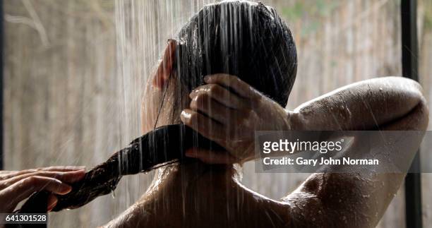 headshot, hispanic woman taking a shower - frau duschen stock-fotos und bilder