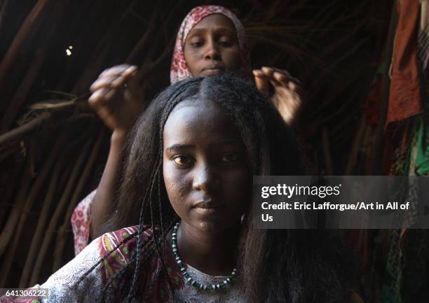 Afar woman having a traditional hairstyle inside her hut on January 15, 2017 in Afambo, Ethiopia.