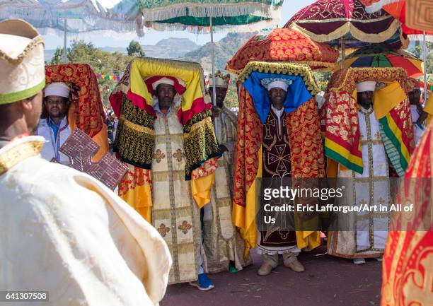Ethiopian priests carrying some covered tabots on their heads during Timkat epiphany festival on January 19, 2017 in Lalibela, Ethiopia.