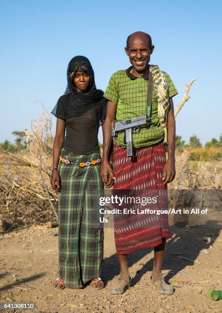 Afar tribe husband with his young second wife on January 21, 2017 in Chifra, Ethiopia.