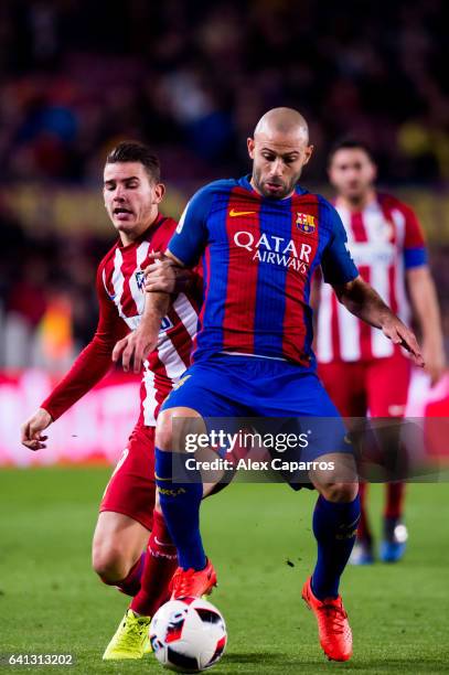 Javier Mascherano of FC Barcelona fights for the ball with Lucas Hernandez of Atletico de Madrid during the Copa del Rey semi-final second leg match...