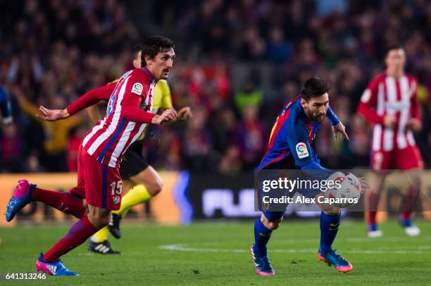 Lionel Messi of FC Barcelona fights for the ball with Stefan Savic of Atletico de Madrid during the Copa del Rey semi-final second leg match between...