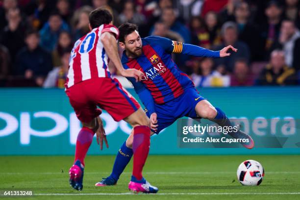 Lionel Messi of FC Barcelona controls the ball next to Juanfran Torres of Atletico de Madrid during the Copa del Rey semi-final second leg match...