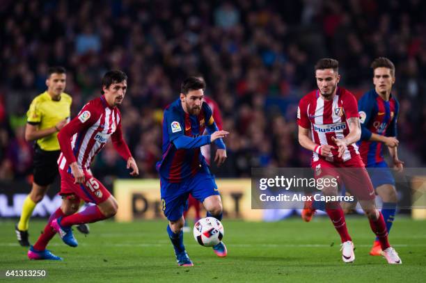 Lionel Messi of FC Barcelona competes for the ball with Saul Niguez of Atletico de Madrid during the Copa del Rey semi-final second leg match between...