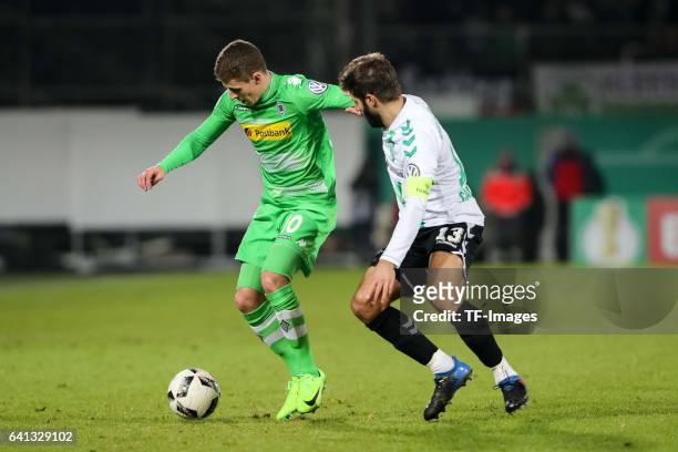 Thorgan Hazard of Borussia Moenchengladbach and Marco Caligiuri of Greuther Fuerth battle for the ball during the DFB Cup match between SpVgg...