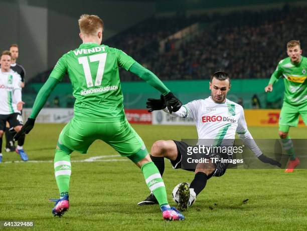 Serdar Dursun of Greuther Fuerth and Oscar Wendt of Borussia Moenchengladbach battle for the ball during the DFB Cup match between SpVgg Greuther...