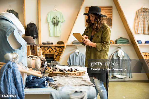 a female in her clothing store. - clothing store stock pictures, royalty-free photos & images