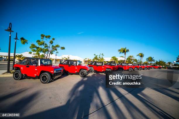 small red electric hummers awaiting tourists, grand turk - hummer stock pictures, royalty-free photos & images