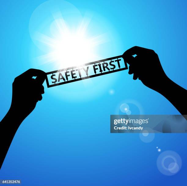 holding the words of "safety first" - sun safety stock illustrations