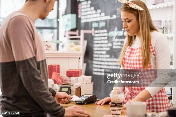 small business owner accepting payment with contactless credit card reader - order pad stock pictures, royalty-free photos & images