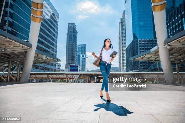 fashionable woman walking down the city streets - bangkok city stock pictures, royalty-free photos & images