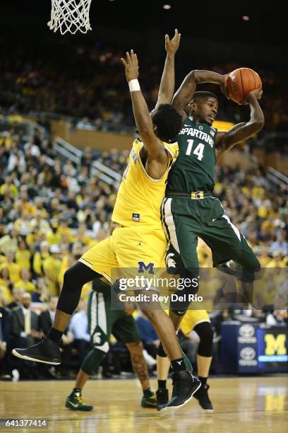 Eron Harris of the Michigan State Spartans grabs the rebound from Derrick Walton Jr. #10 of the Michigan Wolverines at Crisler Arena on February 7,...