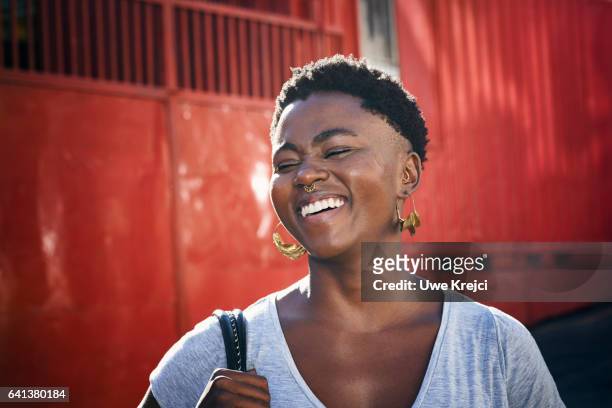 portrait of young woman laughing - candid women fotografías e imágenes de stock