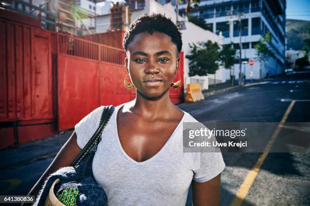 Portrait of young confident woman in the city