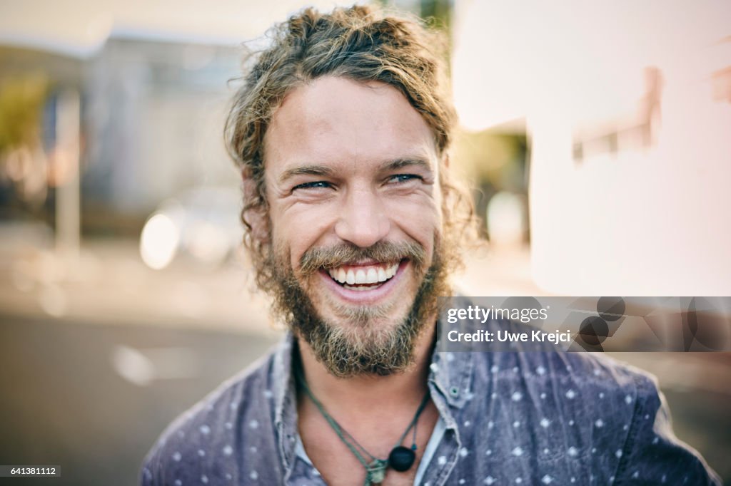 Young bearded man smiling